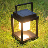 LETRY outdoor table lamp lit for cozy evening patio ambience.