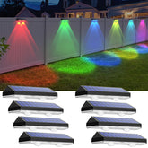 LIANGLOME solar fence light in warm white on surface, for gentle outdoor illumination.