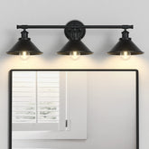 Licperron 3-light black vanity light with matte metal shade over a bathroom mirror.