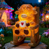 LIULO TOOL light-up Highland cow figurine on chair glowing at night for whimsical outdoor charm