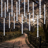 LJLNION 24-tube meteor shower lights brighten outdoor trees and rooftops.