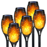LNRYY outdoor solar torch lights flicker brightly at dusk along a garden path.