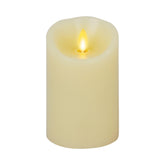 Luminara moving flame ivory candle with lifelike glow on a mantle.
