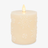 Luminara White Swan Snowflake embossed candle glows as a cozy winter centerpiece