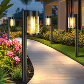 Mancra solar lights outdoor 10-pack illuminate a garden path with warm amber glow.