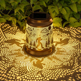 Miggley Bigfoot solar lantern hanging from a tree for warm garden ambience.