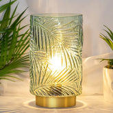 MJ PREMIER leaf-vein glass lamp with warm glow on shelves.