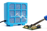 MUIN solder fume extractor with 3-stage filtration close-up capturing fumes at the source.