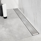 Neodrain Quadrato grate close-up in brushed stainless for a modern bathroom.