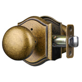 Newlaking interior privacy knob in brass finish on a bedroom door.