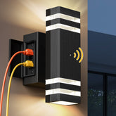 NookNova outdoor porch light with outlet illuminating the entry at dusk