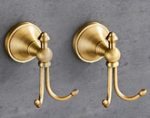 NSCMQSL vintage-style wall-mounted towel hooks in antique brass enhance bathroom organization.