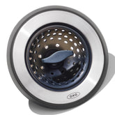 OXO Good Grips 2-in-1 sink strainer stopper in use traps debris while filling or draining.