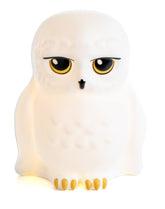 Paladone Hedwig night light on a shelf providing soft bedside illumination.