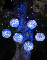 PARTPHONER solar lantern with cracked glass glows warmly for outdoor evenings.