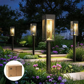 Philips solar pathway lights with glass and metal illuminate a garden path