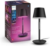 Philips Hue Go portable lamp in black on a table delivering mood lighting