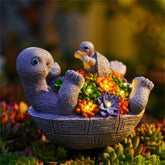 Pohabery solar turtle figurine glows softly in the garden at night.