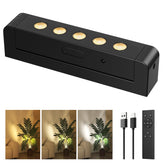 PopoIron LED spotlight highlighting wall art with cordless placement.