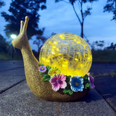 QCF Solar Snail Garden Light glows softly for outdoor ambiance.