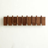 Quellance wood coat rack wall mount with piano-key design saves space in entryways.