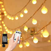 RaThun 65.6ft warm white globe string lights illuminate outdoor trees with a cozy glow