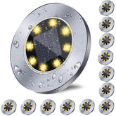 Rayolon solar ground lights illuminate pathways with a warm, wire-free glow.