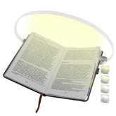 ROOKIELEDS clip-on book light attached to a page for hands-free reading.