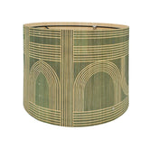 Rustic bamboo lamp shade with green geometry pattern for warm ambient lighting.
