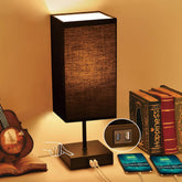 Sailstar table lamp with black base and square shade for a cozy bedroom ambiance.