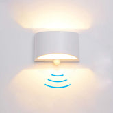 SERDEN LED wall sconce front view glowing in warm 3000K light for cozy ambience