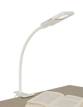 SHABBOSLITE clip-on lamp attached to headboard for focused bedtime reading