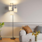 SIBRILLE dimmable floor lamp with three linen shades brightens a cozy living room.