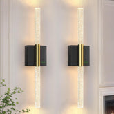 Slypadan wall sconce with crystal accents creates warm ambient lighting for elegant spaces.