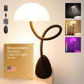 Smallish Shroommate clip-on light on a dorm bed rail, ideal for late-night reading.