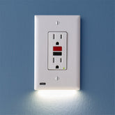 SnapPower GuideLight mounted on a GFCI outlet providing flush, safe lighting at night.