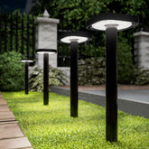 Sunco square solar pathway light front view glows softly along a garden path