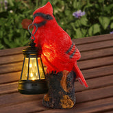 Suzile Cardinal Garden Statue with Solar Lantern glowing at dusk to illuminate a path