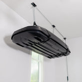 Teal Triangle ceiling storage hoist lifting a cargo box overhead for clutter-free garage.
