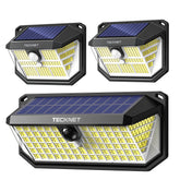 TECKNET solar lights outdoor 3-pack front view illuminating pathways with broad coverage