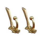 Tiazza antique brass coat hooks on wall mount for sturdy storage of coats and bags.