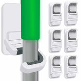 Tinkeep broom holder attached to wall offers easy, clutter-free storage.