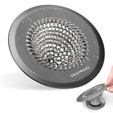 TRAPMATE shower hair drain catcher installed on a drain to prevent clogs