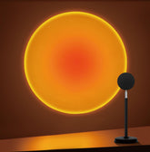Tsrarey Sunset Lamp Projector casts warm sunset glow on wall.