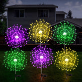 Tujoe Mardi Gras purple solar firework lights brighten garden decor at dusk.