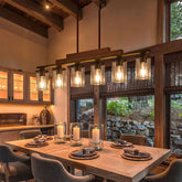 Twig Farmhouse Chandelier with six lights creates warm dining ambience above the table.