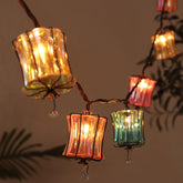 TWINKVILLA Prism lantern bulbs illuminate a cozy outdoor dining area.