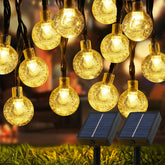 USOKYO outdoor solar lights illuminate the yard with warm white globes for cozy evenings.