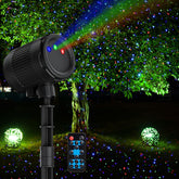 VanSmaGo laser christmas projector outdoors casting RGB fireflies on the home façade.