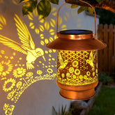 Vcdsoy hummingbird solar lantern on patio glows warmly for evenings.